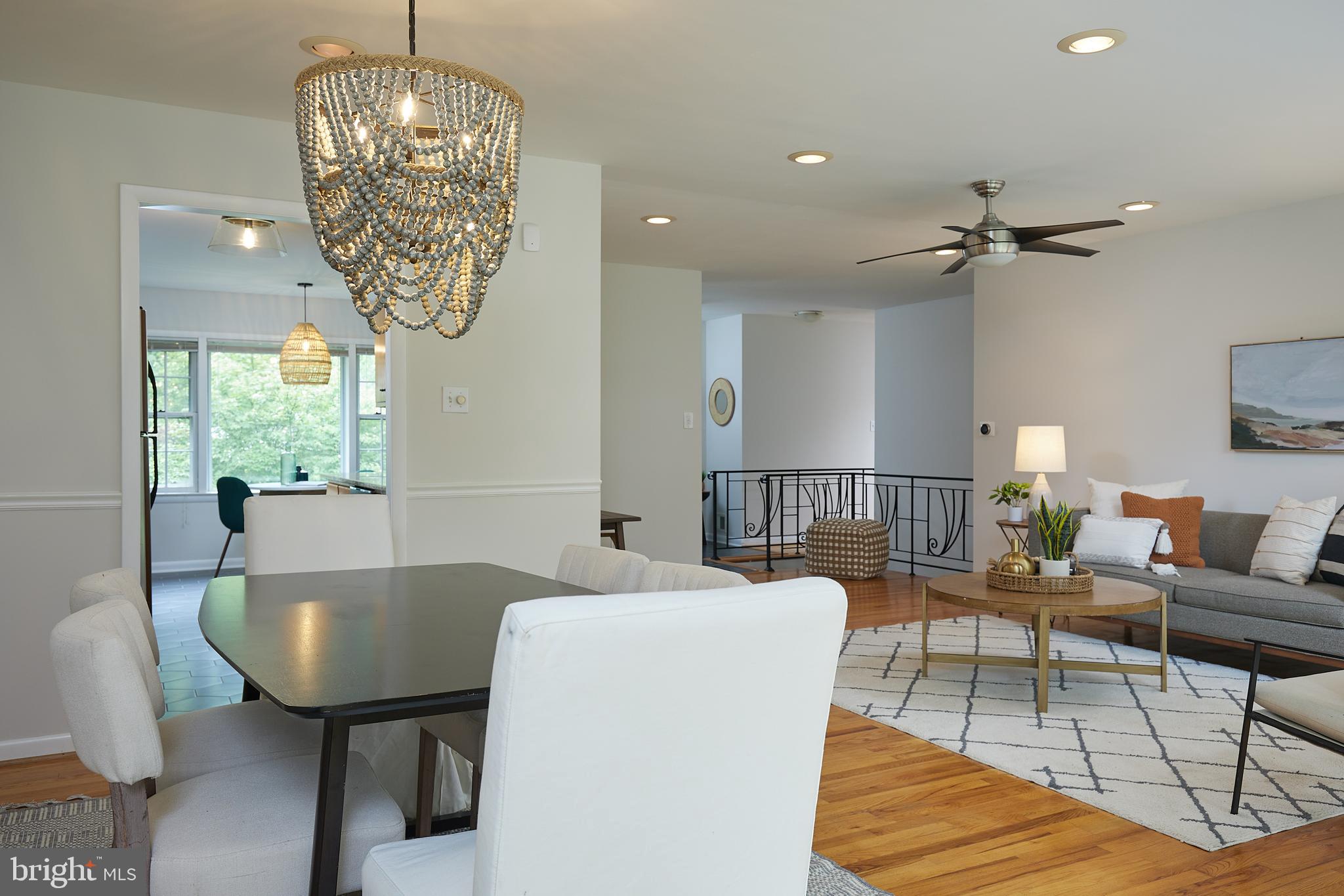 10611 Glenwild Road Silver Spring, MD 20901 - Photo 36 of 39 a living room with furniture a chandelier and a window