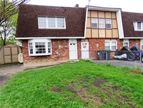 a view of a house with a yard and sitting space