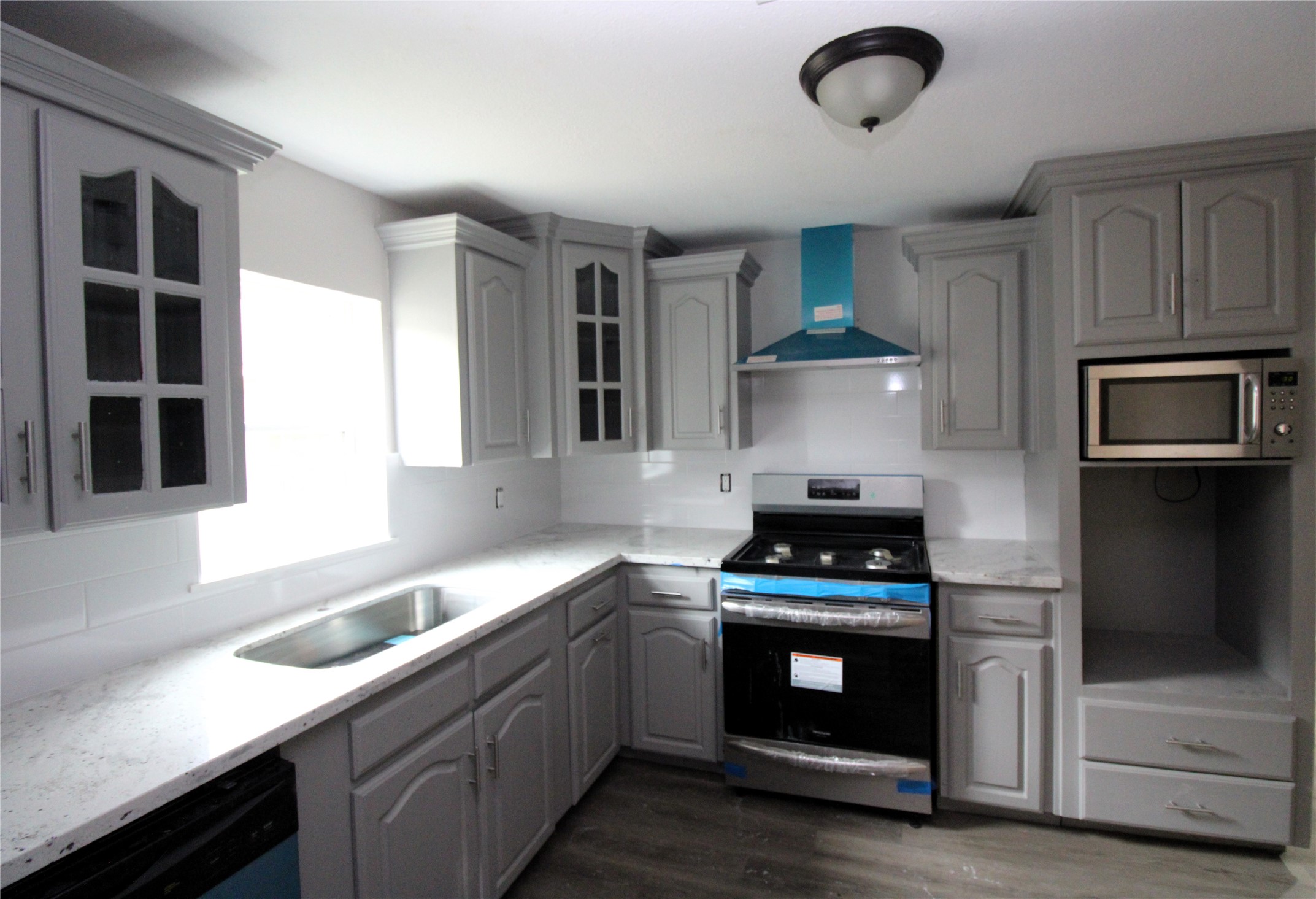 207 East Bernard Street Clute, TX 77531 - Photo 6 of 20 New gas freestanding range with stainless vent hood.