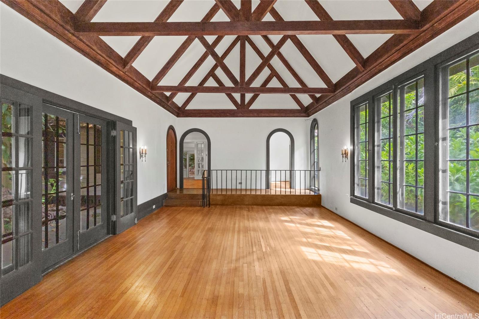 a view of swimming pool with a large window and wooden floor