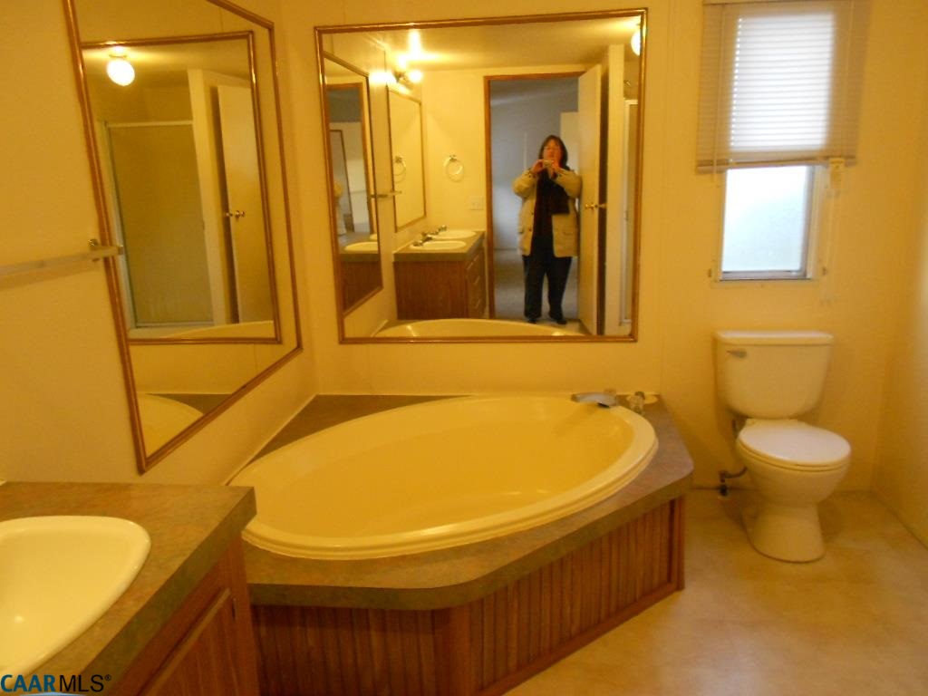 3135 Orange Road Aroda, VA 22709 - Photo 7 of 10 a bathroom with a tub sink and mirror