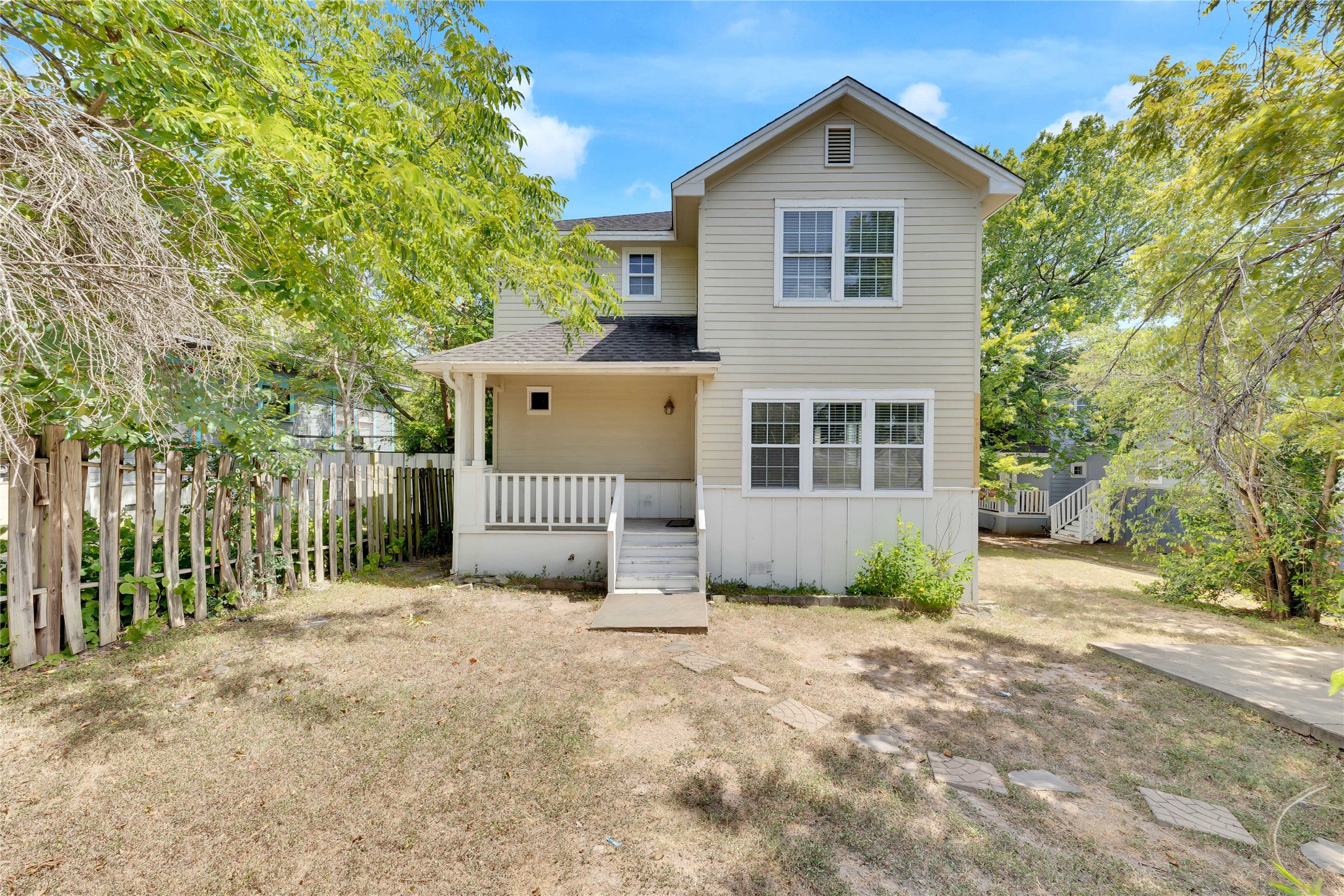 2201 East 18th Street, Unit B Austin, TX 78702 - Photo 21 of 25 A classic two-story home features a welcoming covered porch, offering a quaint curb appeal.