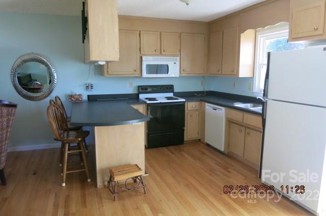205 Towne Court Conover, NC 28613 - Photo 3 of 19 a kitchen with a refrigerator a stove a microwave and furniture