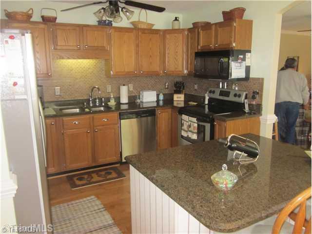 313 Cook Florist Road Reidsville, NC 27320 - Photo 9 of 16 Kitchen. Kitchen with granite counter tops and tile back splash.