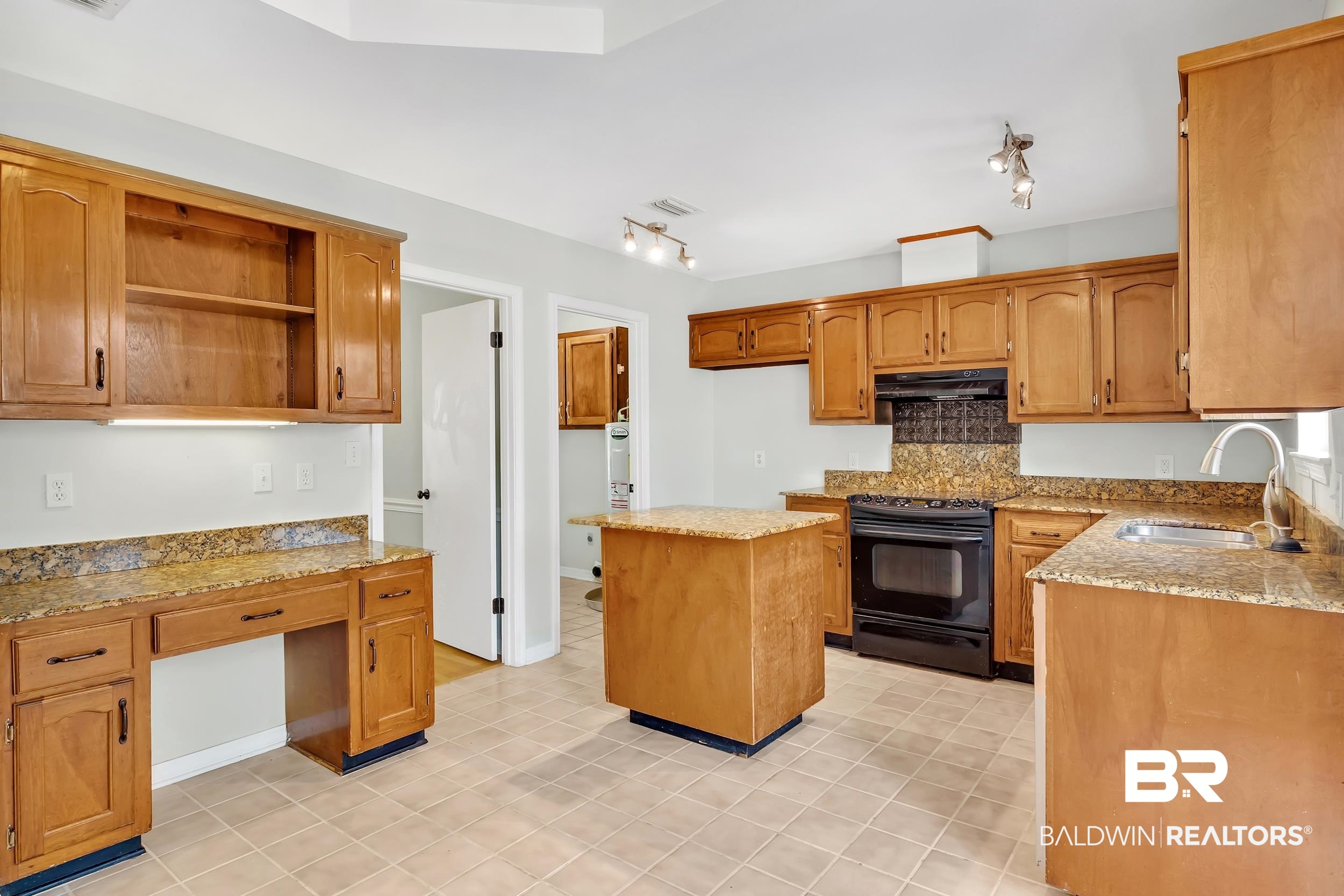 6616 Conde Court Mobile, AL 36695 - Photo 10 of 27 Kitchen with light stone counters, a sink, decorative backsplash, black range with electric stovetop, and under cabinet range hood