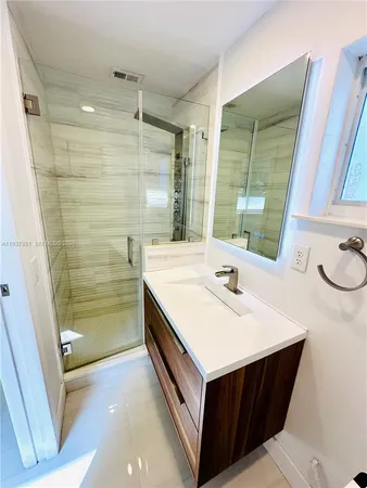 a bathroom with a tub sink and a mirror