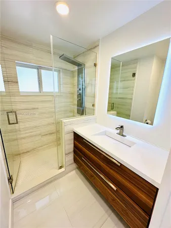 a bathroom with a sink and mirror