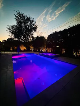 a view of swimming pool with sunset