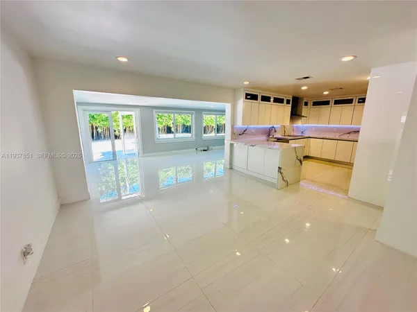 a kitchen with a refrigerator and a counter top space