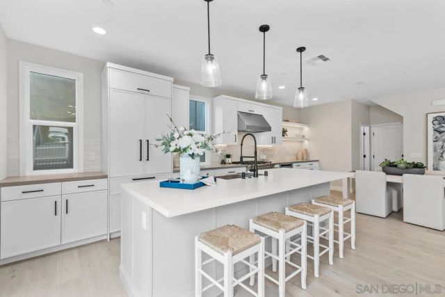 a large kitchen with kitchen island a sink and a stove