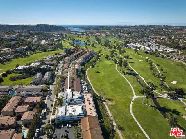 an aerial view of a residential houses with outdoor space