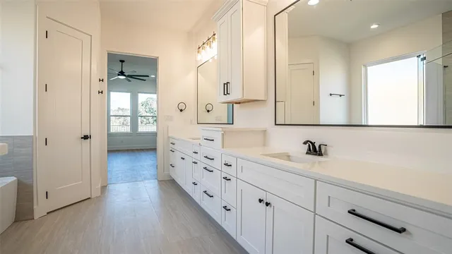 a bathroom with double vanity sink and mirror