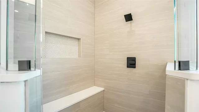 a bathroom with a shower and a mirror