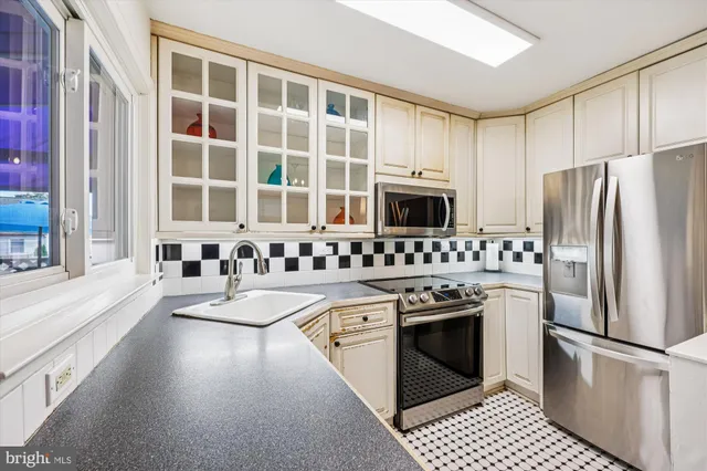 a kitchen with a stove a sink and a refrigerator