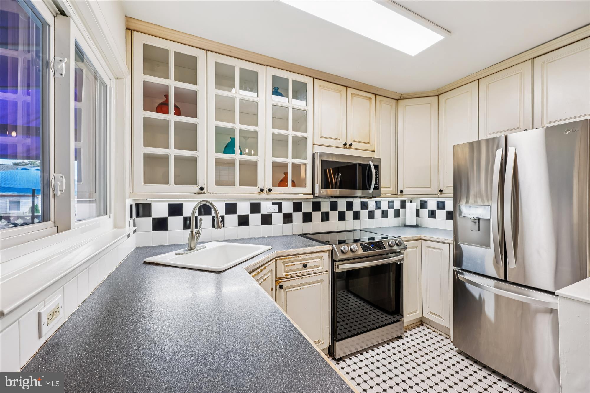 1605 Windham Lane Silver Spring, MD 20902 - Photo 14 of 65 a kitchen with stainless steel appliances granite countertop a stove a sink and a refrigerator