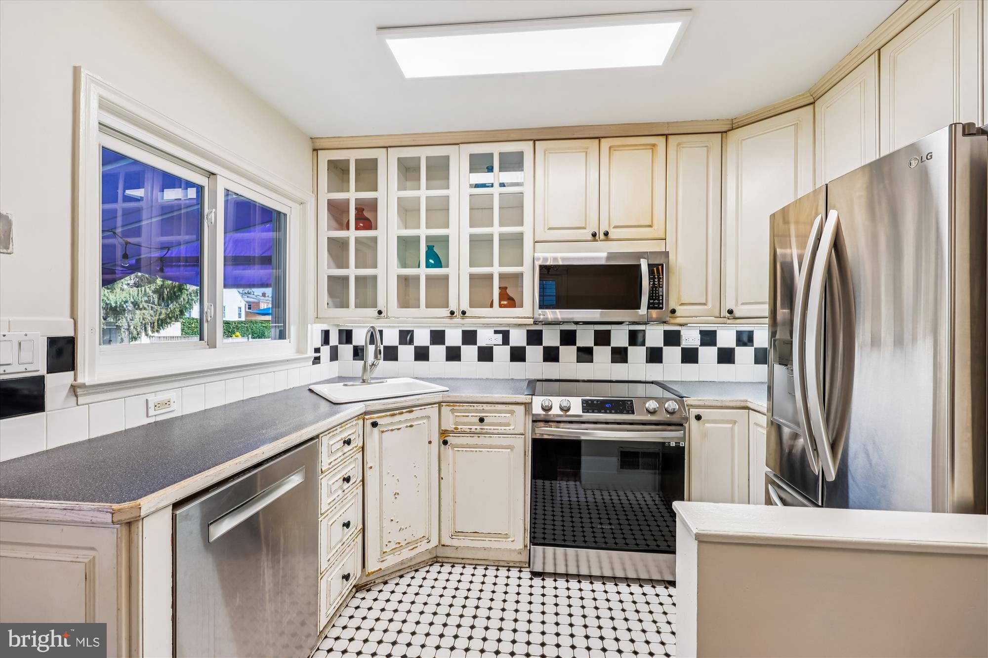 1605 Windham Lane Silver Spring, MD 20902 - Photo 16 of 65 a kitchen with a stove a sink and a refrigerator