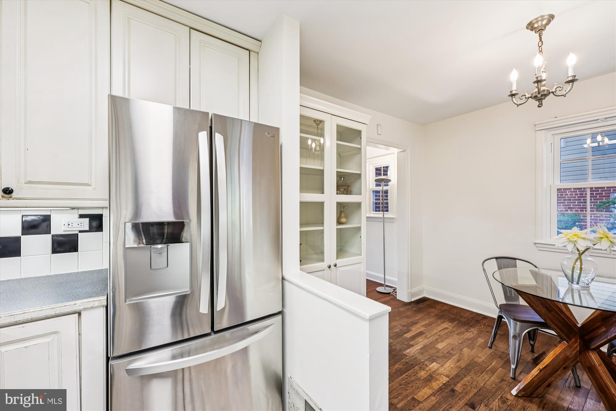 1605 Windham Lane Silver Spring, MD 20902 - Photo 18 of 65 a kitchen with stainless steel appliances a refrigerator and a dining table