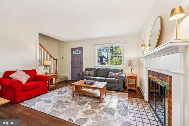 a living room with furniture or wooden floor and a flat screen tv