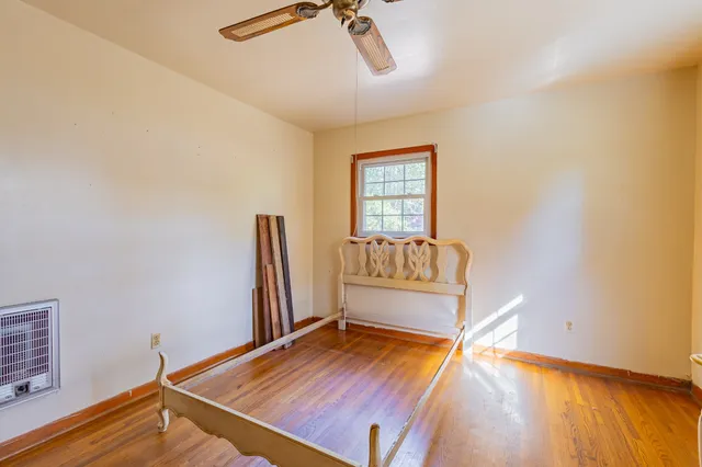 a kitchen with granite countertop wooden cabinets a dining table and chairs