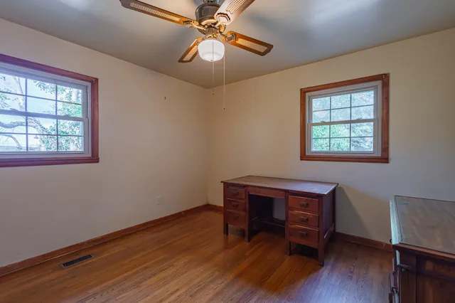 a living room with fireplace furniture and a large window