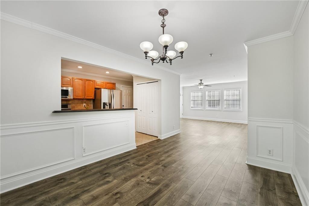 2825 Northeast Expressway, Unit F3 Atlanta, GA 30345 - Photo 12 of 45 a view of a kitchen with granite countertop a stove top oven a sink and dishwasher with wooden floor