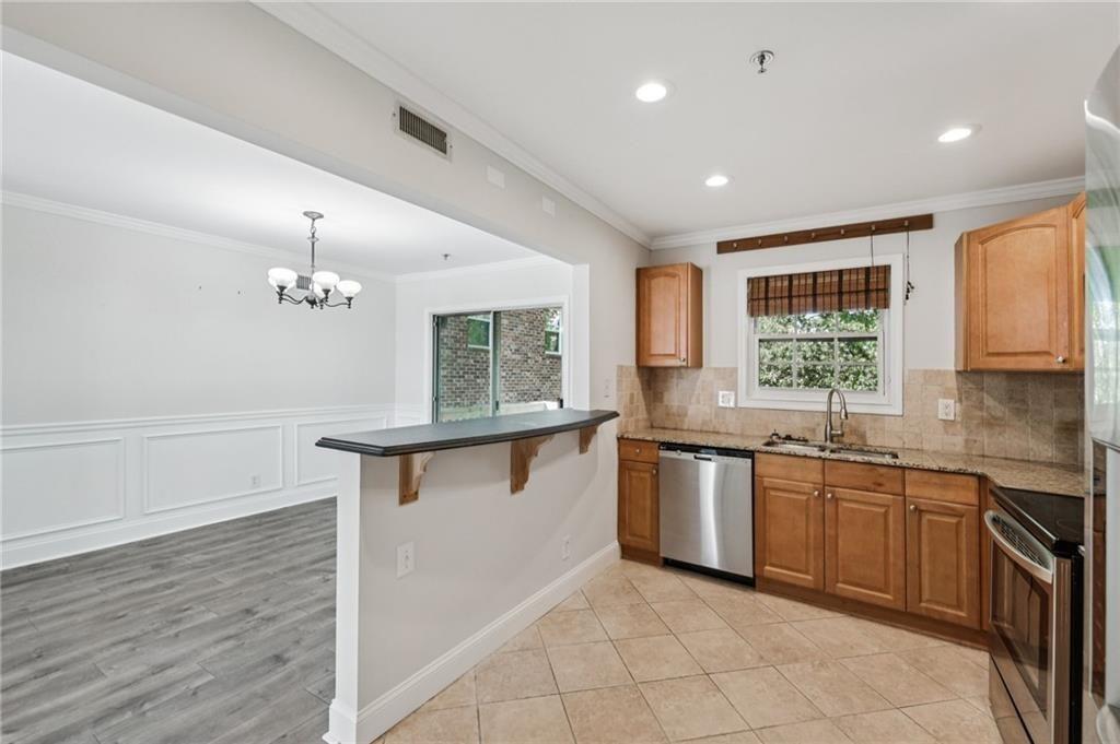 2825 Northeast Expressway, Unit F3 Atlanta, GA 30345 - Photo 14 of 45 a kitchen with stainless steel appliances granite countertop a sink dishwasher a stove and a refrigerator