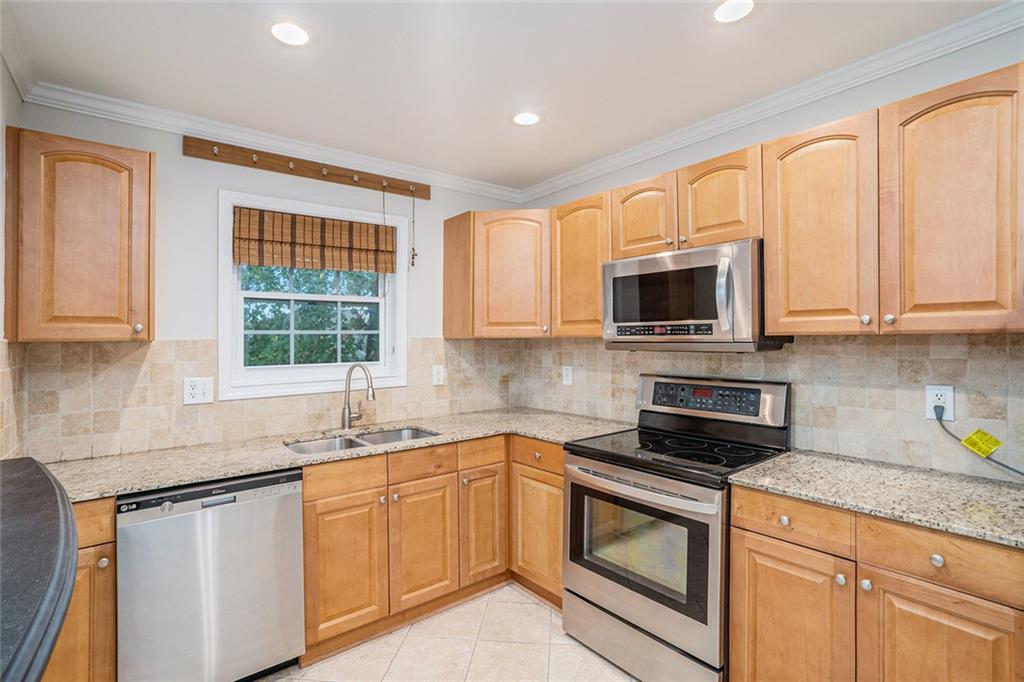 2825 Northeast Expressway, Unit F3 Atlanta, GA 30345 - Photo 16 of 45 a kitchen with stainless steel appliances granite countertop white cabinets a sink and a stove