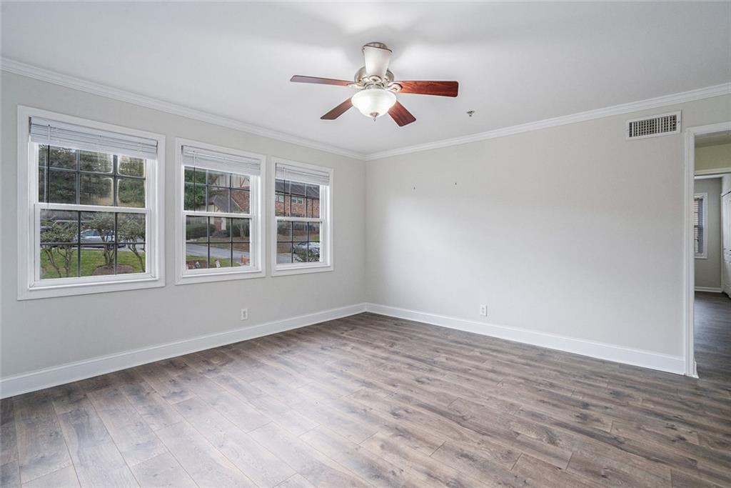 2825 Northeast Expressway, Unit F3 Atlanta, GA 30345 - Photo 4 of 45 a view of an empty room with wooden floor and a window