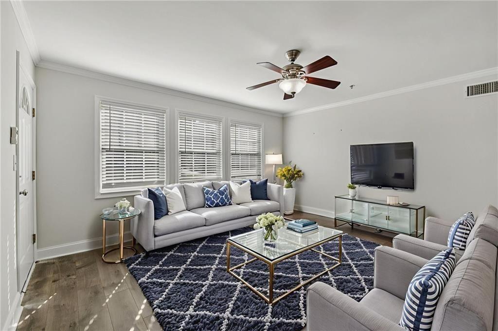 2825 Northeast Expressway, Unit F3 Atlanta, GA 30345 - Photo 6 of 45 a living room with furniture a flat screen tv and a window