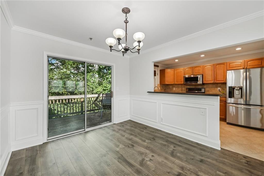 2825 Northeast Expressway, Unit F3 Atlanta, GA 30345 - Photo 9 of 45 a view of a kitchen with a stove wooden cabinet and a refrigerator