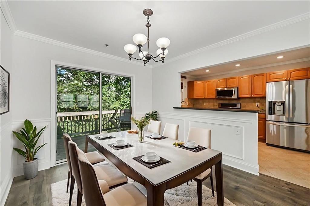 2825 Northeast Expressway, Unit F3 Atlanta, GA 30345 - Photo 10 of 45 a view of a dining room with furniture a chandelier and wooden floor