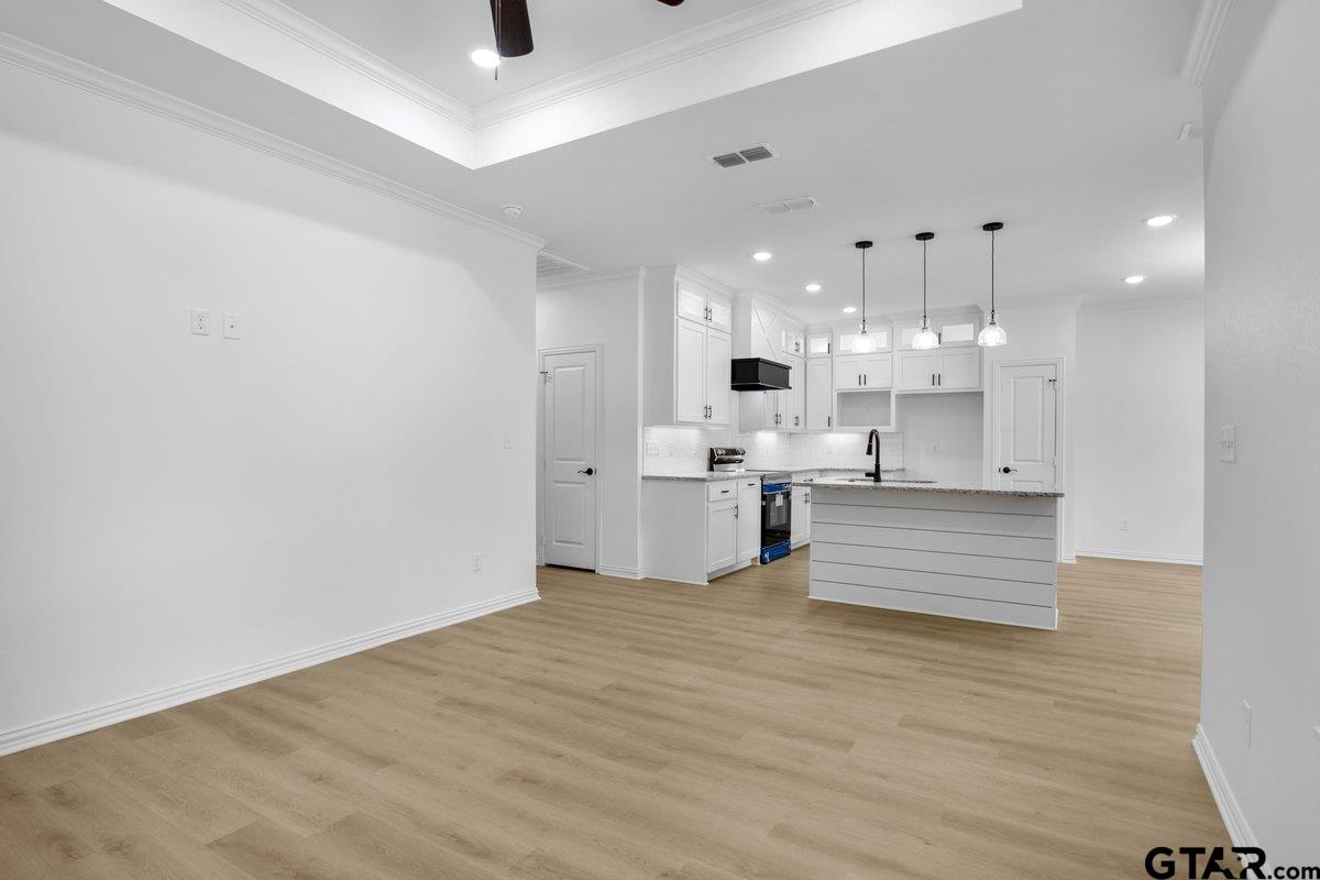 1610 West Barrett Street Tyler, TX 75702 - Photo 11 of 32 a large kitchen with cabinets and wooden floor