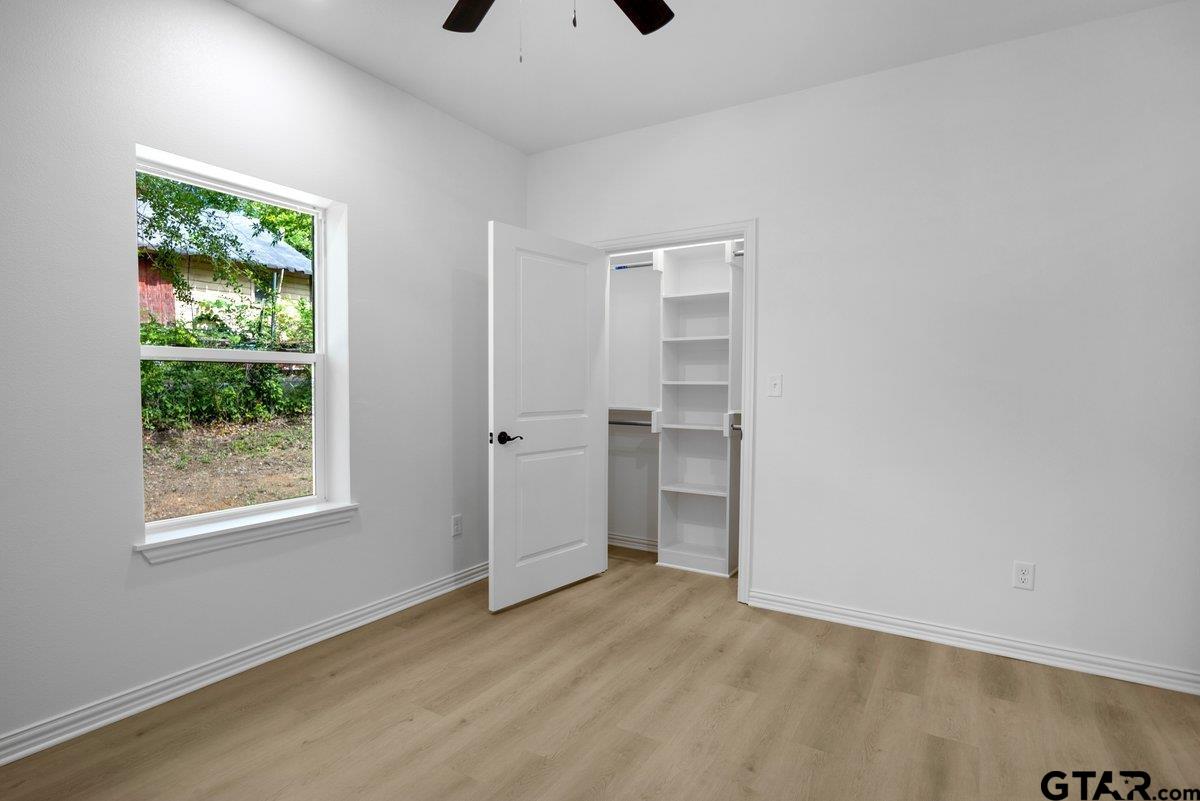 1610 West Barrett Street Tyler, TX 75702 - Photo 15 of 32 a view of empty room with wooden floor and fan