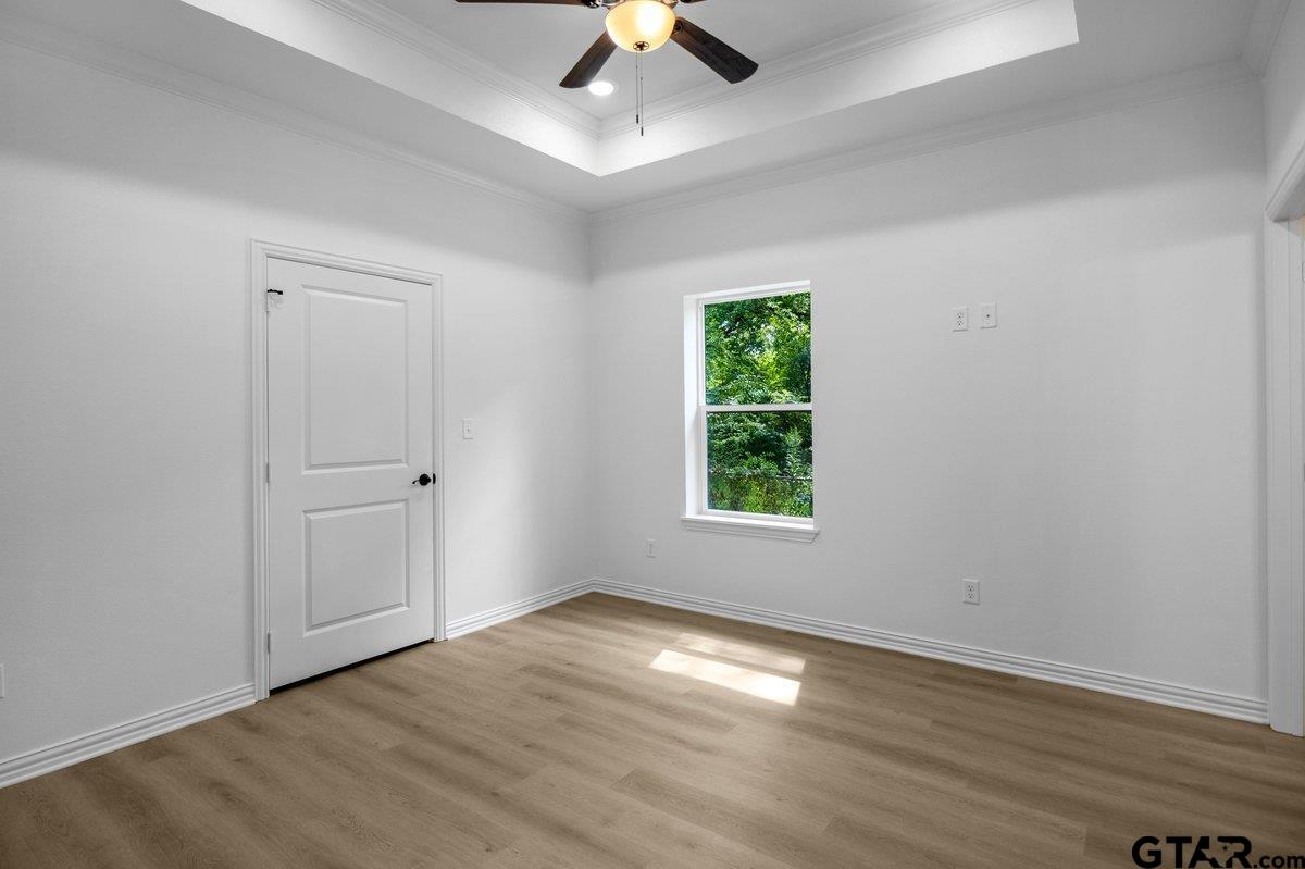 1610 West Barrett Street Tyler, TX 75702 - Photo 18 of 32 wooden floor in an empty room with a window