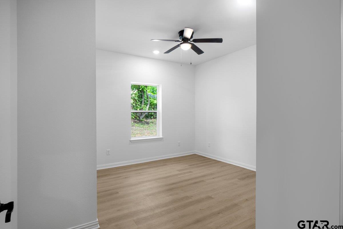 1610 West Barrett Street Tyler, TX 75702 - Photo 22 of 32 a view of empty room with wooden floor and fan