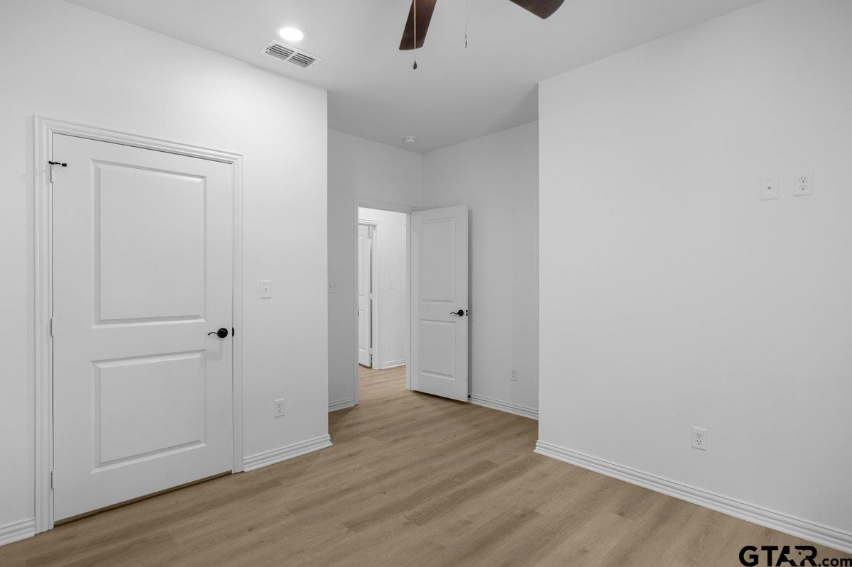 1610 West Barrett Street Tyler, TX 75702 - Photo 24 of 32 a view of an empty room with wooden floor