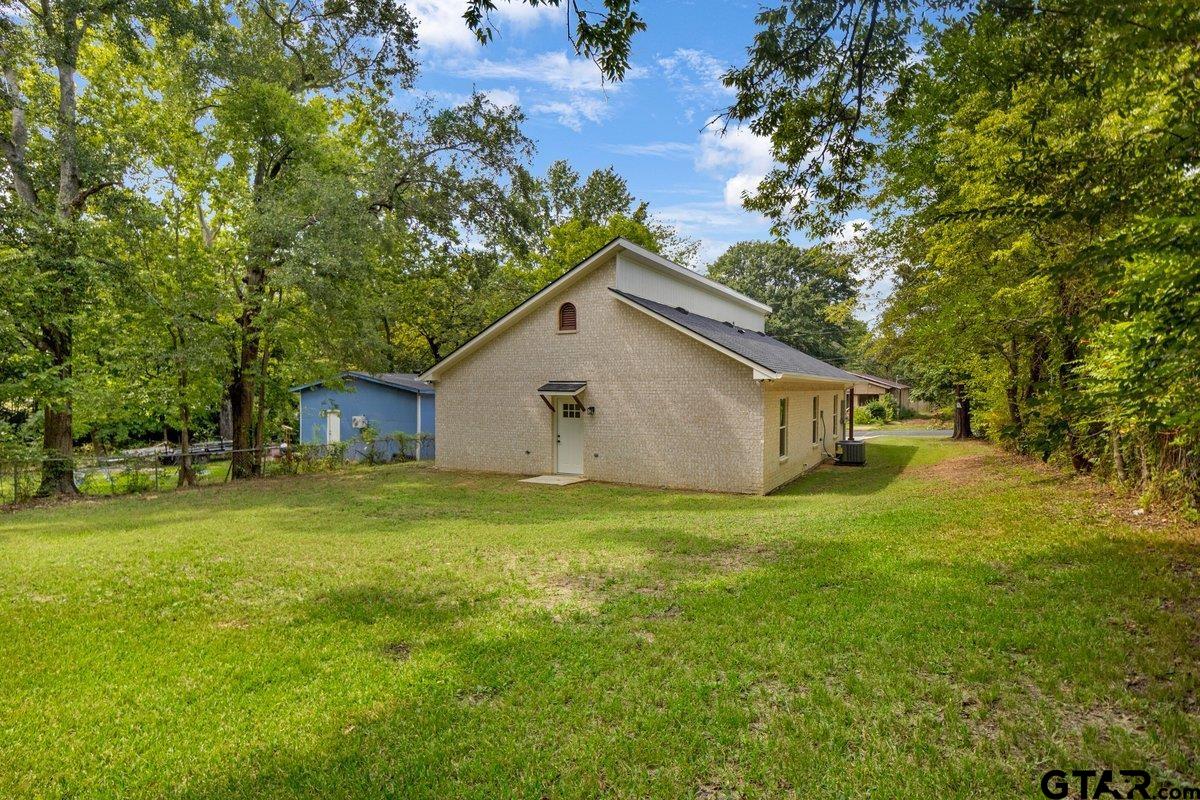 1610 West Barrett Street Tyler, TX 75702 - Photo 27 of 32 a house with huge green field in front of it