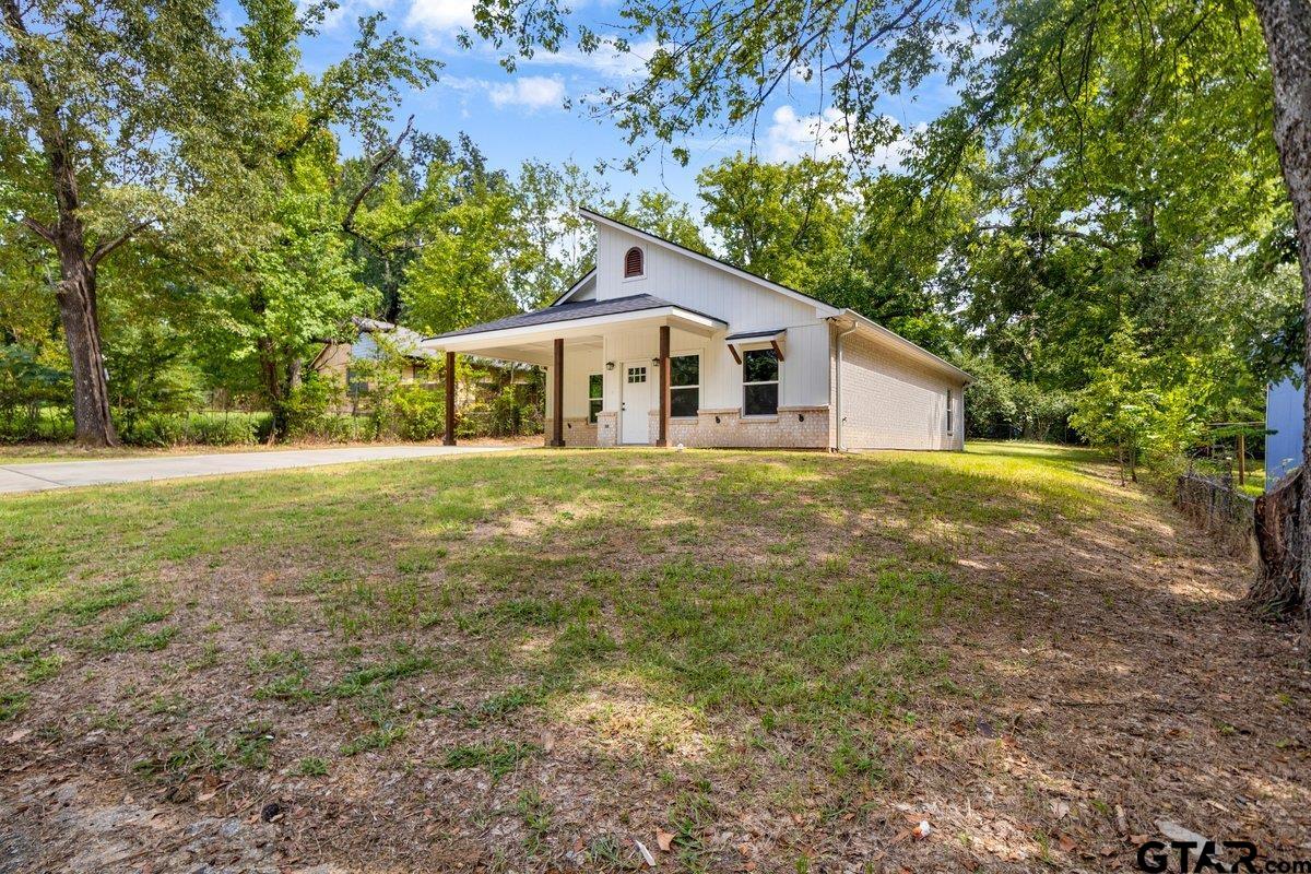 1610 West Barrett Street Tyler, TX 75702 - Photo 3 of 32 a big house with large trees and plants
