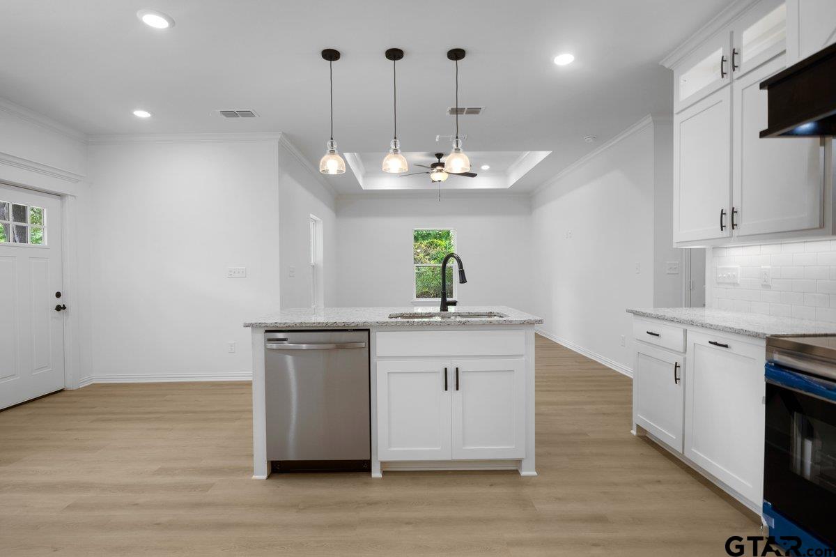1610 West Barrett Street Tyler, TX 75702 - Photo 7 of 32 a kitchen with kitchen island a sink stainless steel appliances and cabinets