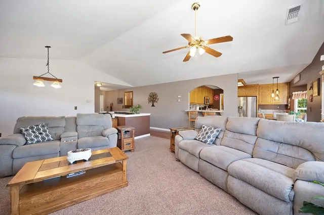 a view of a dining room with furniture wooden floor and a chandelier