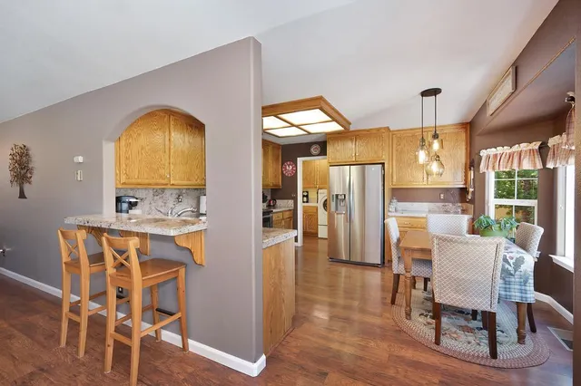 a kitchen with granite countertop a stove top oven microwave and cabinets