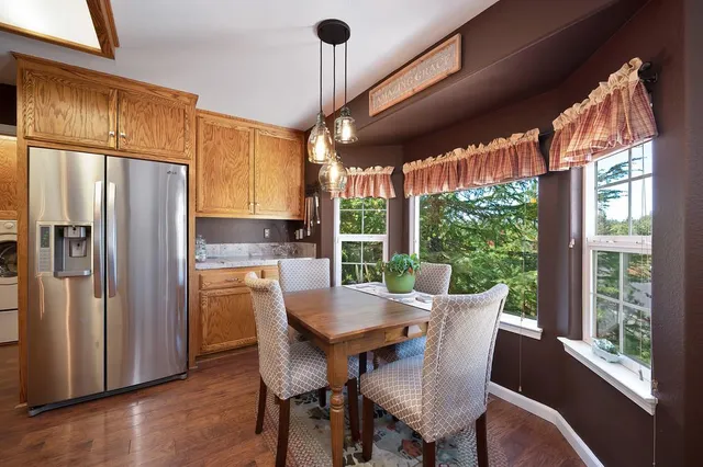 a kitchen with stainless steel appliances granite countertop a stove and refrigerator