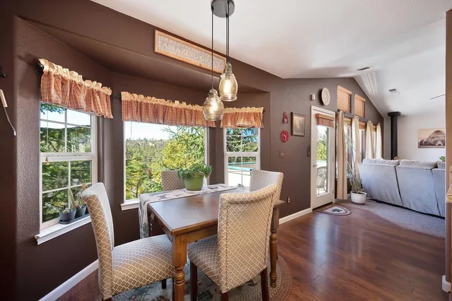 a view of a dining room with furniture large window and wooden floor
