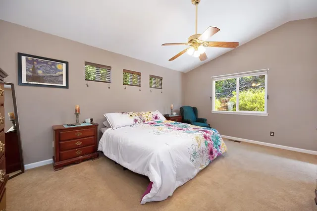 a bathroom with a sink a toilet and a large mirror
