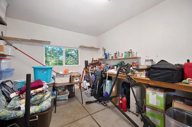 a view of a patio with table and chairs with wooden floor and fence