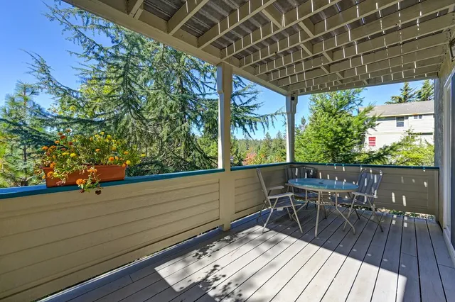a view of a house with a yard and potted plants