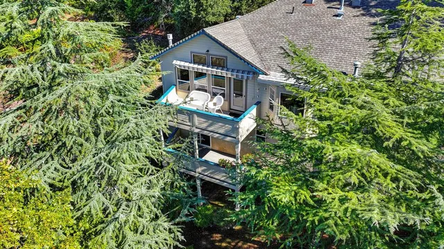 an aerial view of a house with a yard