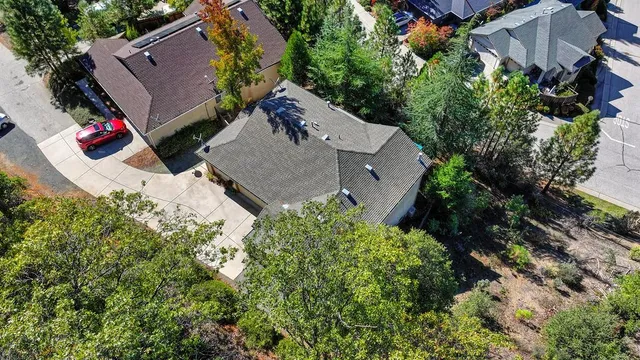 a view of a house with a yard and potted plants