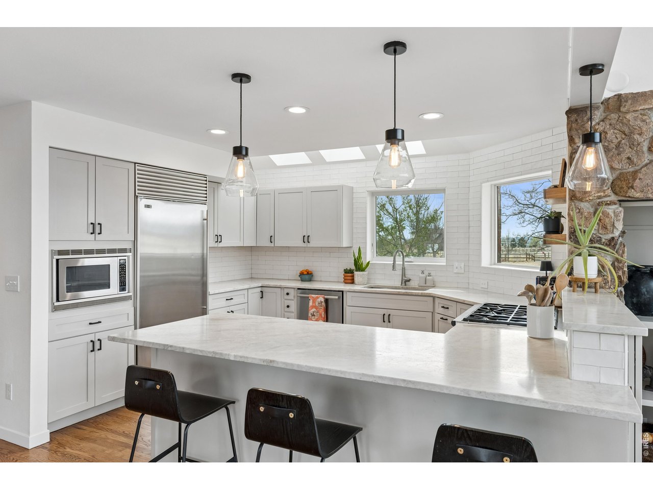 9421 Gunbarrel Ridge Road Boulder, CO 80301 - Photo 14 of 50 a kitchen with stainless steel appliances kitchen island granite countertop a sink a stove and refrigerator