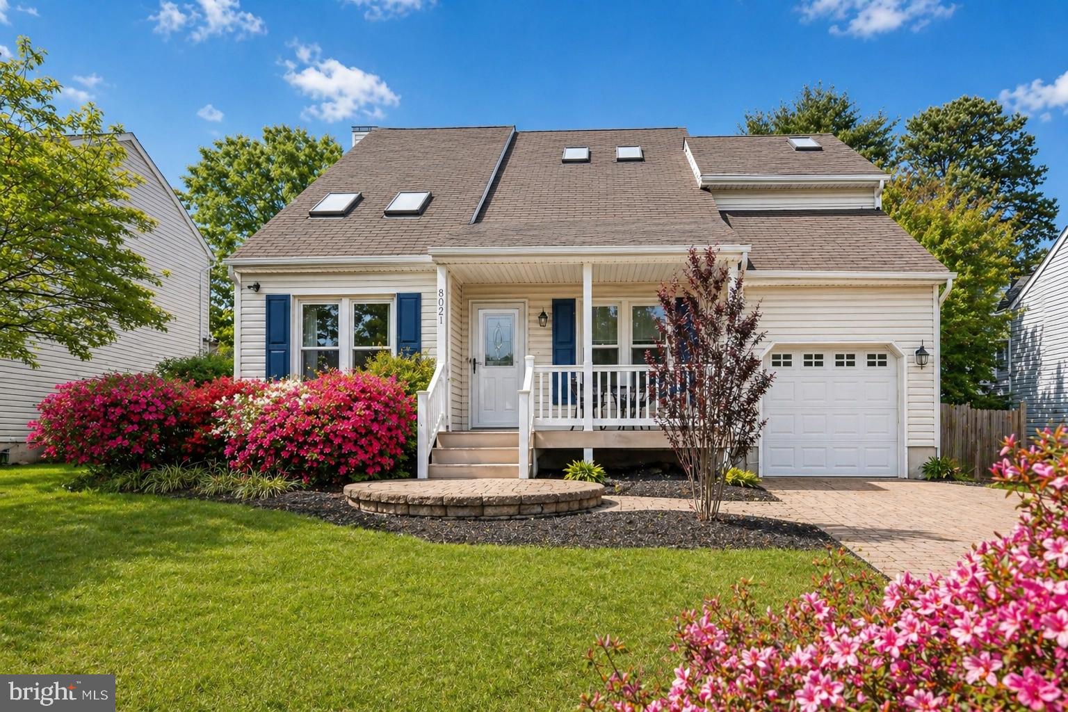 Charming home with vibrant landscaping.